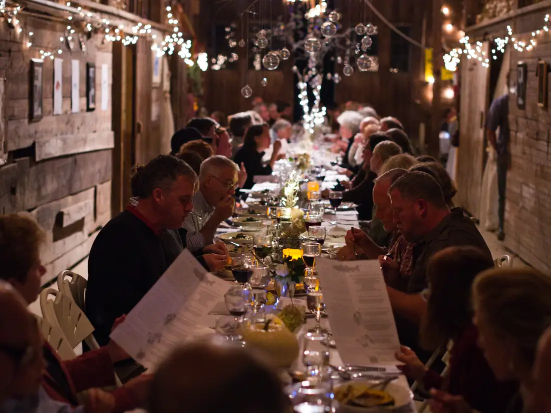 Large group gathering enjoying a delicious meal at Black Trumpet. 