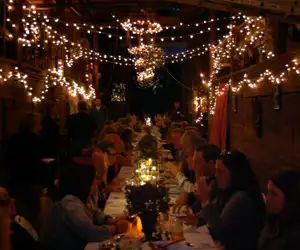 Large group gathering enjoying a delicious meal at Black Trumpet. 